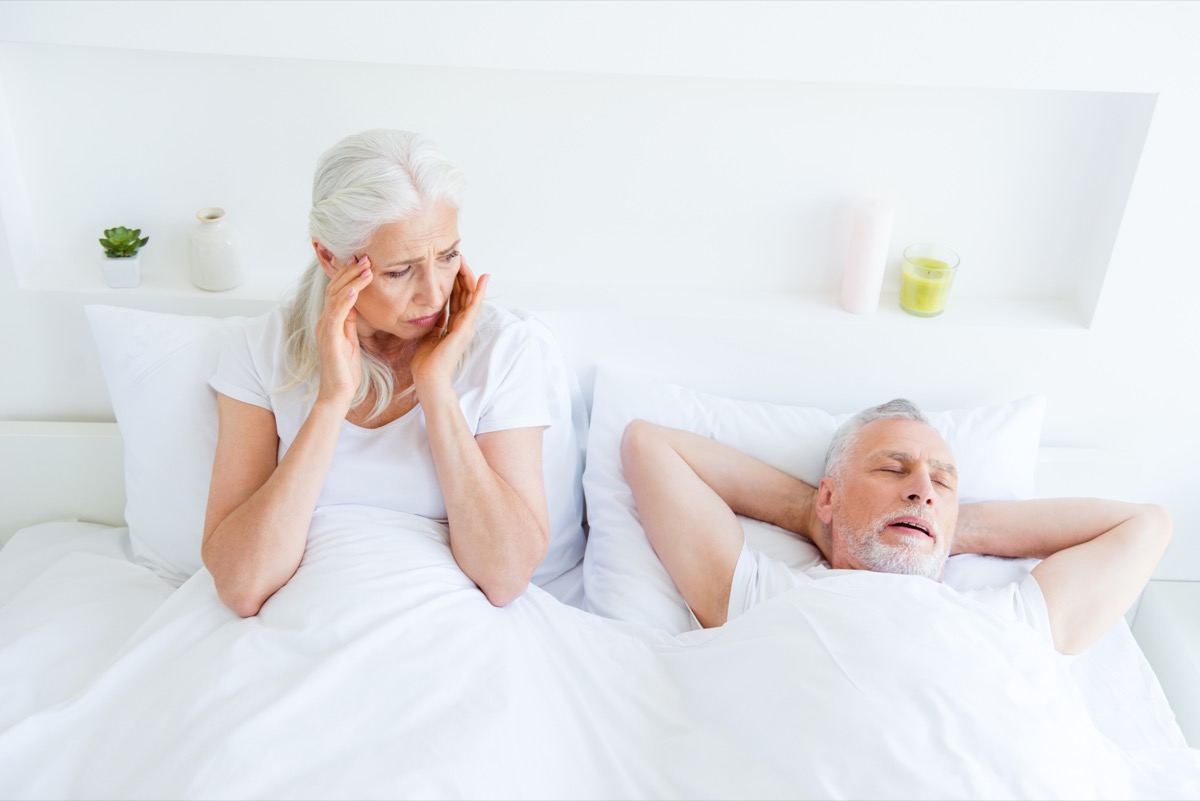 Old couple in bed, woman awake to bored man