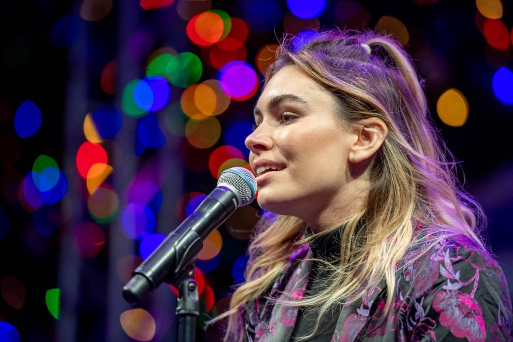 Sophie Simmons sings into a microphone
