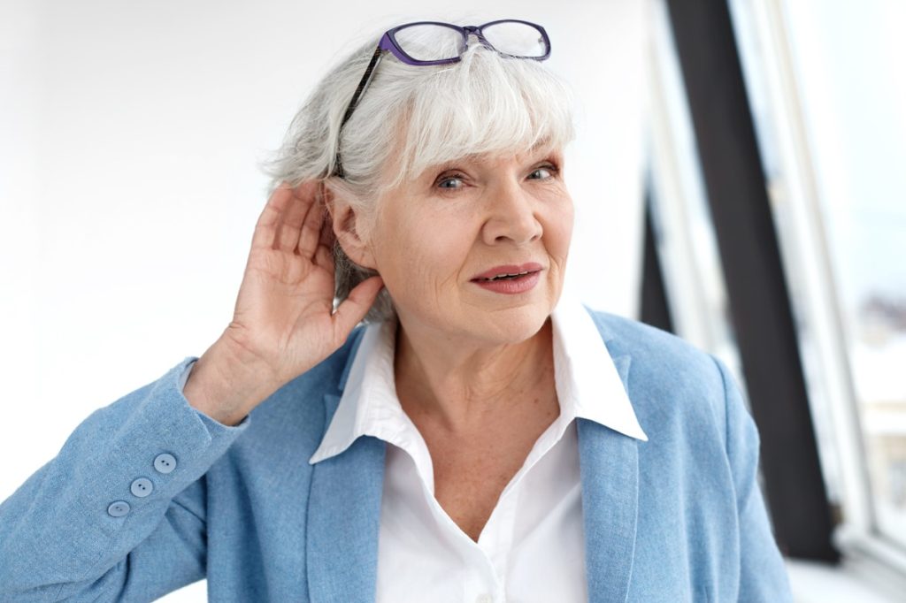 Older woman with hearing problem 