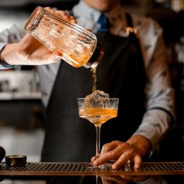 Bartender pouring a drink into a glass
