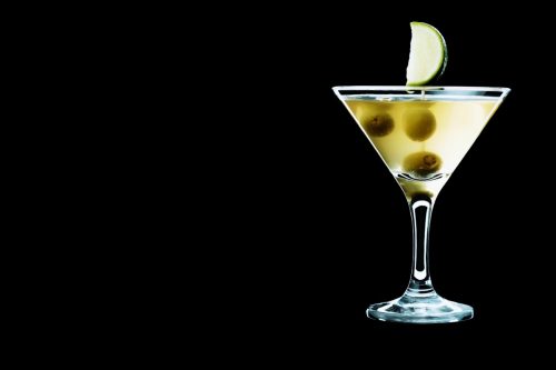 Dirty vodka martini with olives and a lime in it