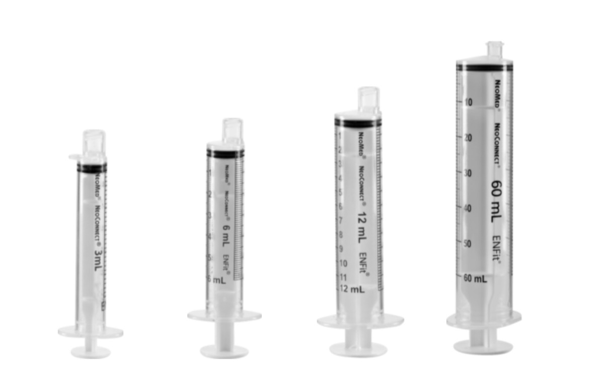 clear enfit syringes on white background