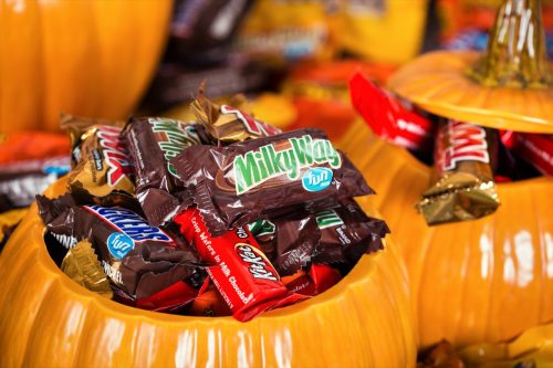 DALLAS, TX - OCTOBER 31, 2015: Decorative pumpkins filled with assorted Halloween chocolate candy made by Mars, Incorporated and the Hershey Company.