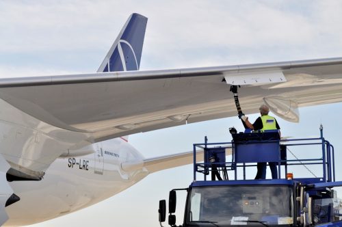 Warsaw, Poland - August 4, 2013: New Boeing 787 Dreamliner of the LOT Polish Airlines - an employee of the service fueling aircraft fuel from tanker truck at Chopin Airport.