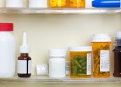 medicine cabinet full of prescription bottles
