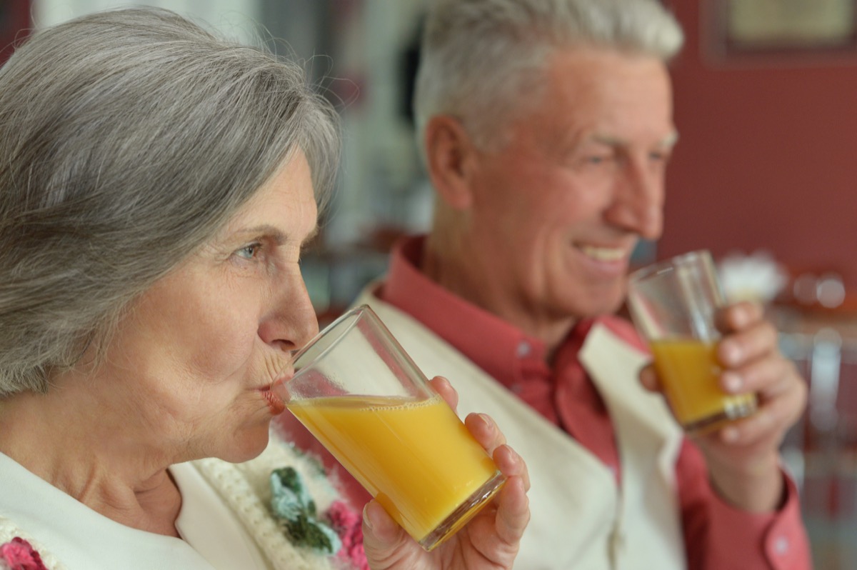 older couple drinking orange juice