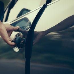 A close up of a person opening a car door