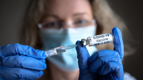Health professional holding covid-19 vaccine