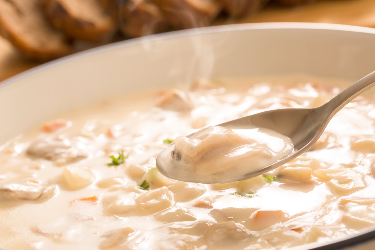 spoon in warm cup of clam chowder