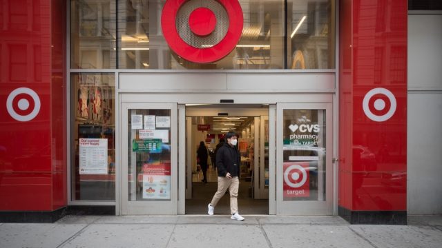 Manhattan, New York. March 24, 2021. A man wearing a mask exits a Target store on 34th street.