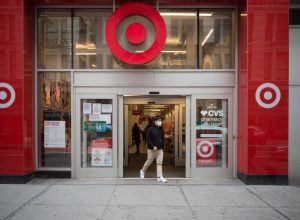 Manhattan, New York. March 24, 2021. A man wearing a mask exits a Target store on 34th street.