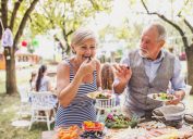 Woman and man eating at a picnic table