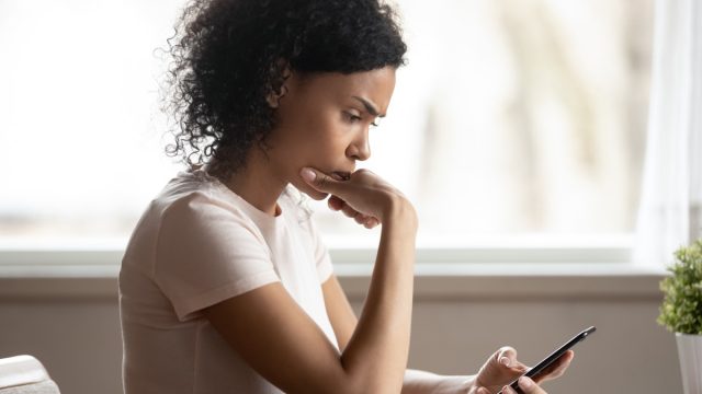 young woman replying to text on smartphone