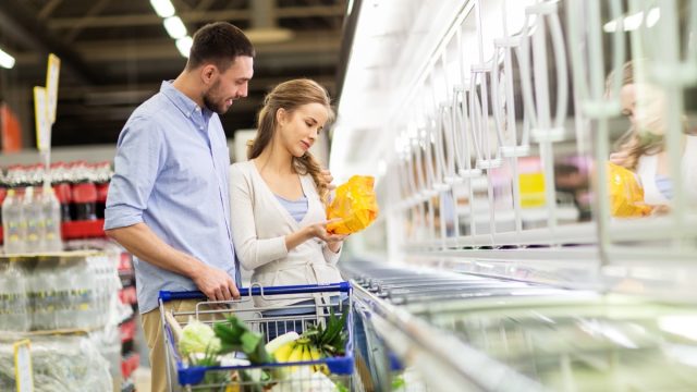 woman and man shopping in supermarket freezer
