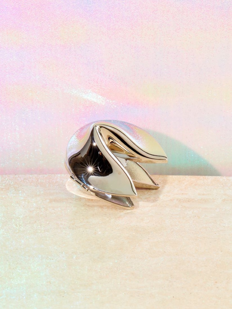 Chrome fortune cookie on iridescent background