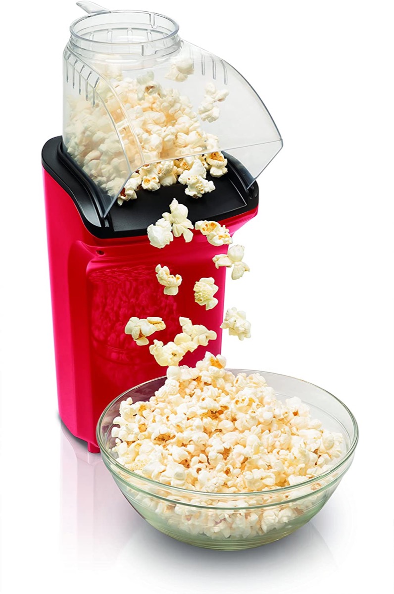 Red popcorn maker with bowl of popcorn
