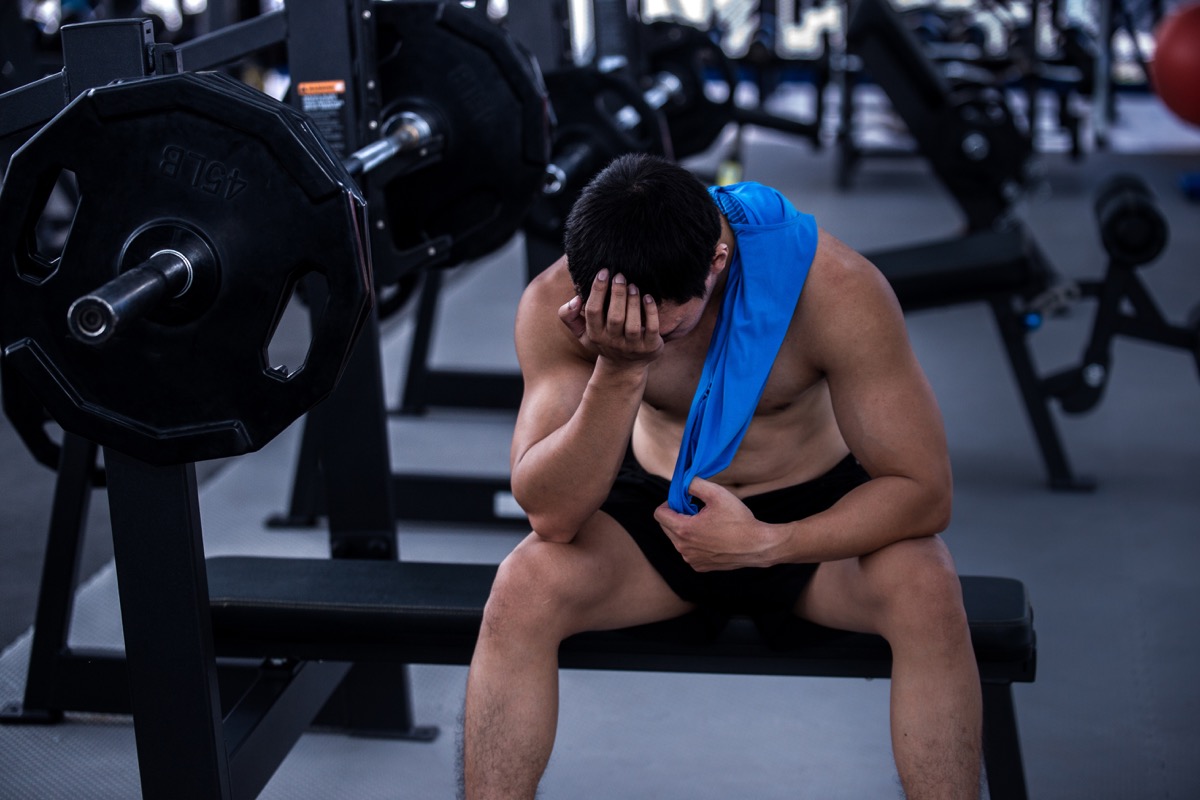 Man at gym with bad headache
