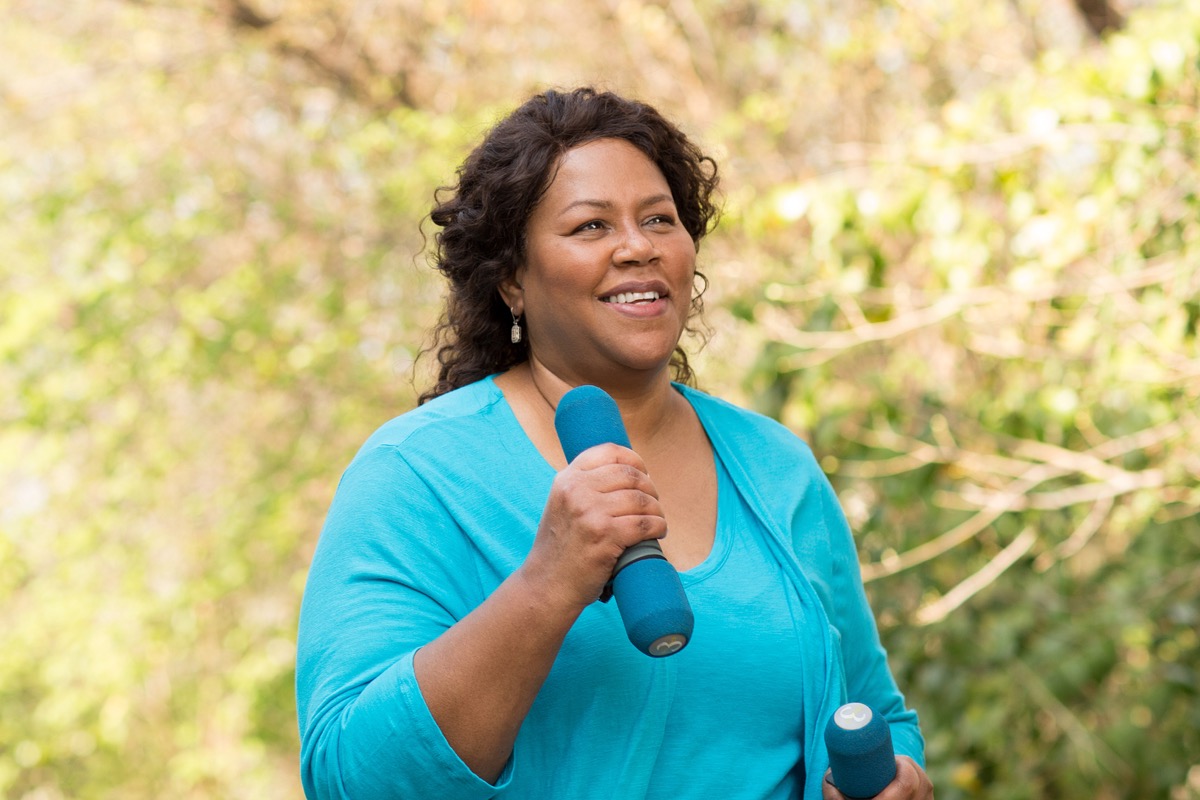Mature African American woman smiling while working out in park