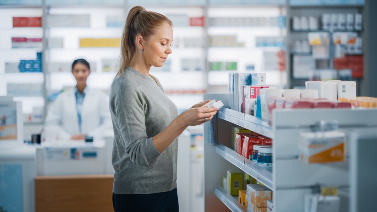 Woman buying medicine at pharmacy