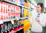 Woman looking for refreshing beverages in the supermarket