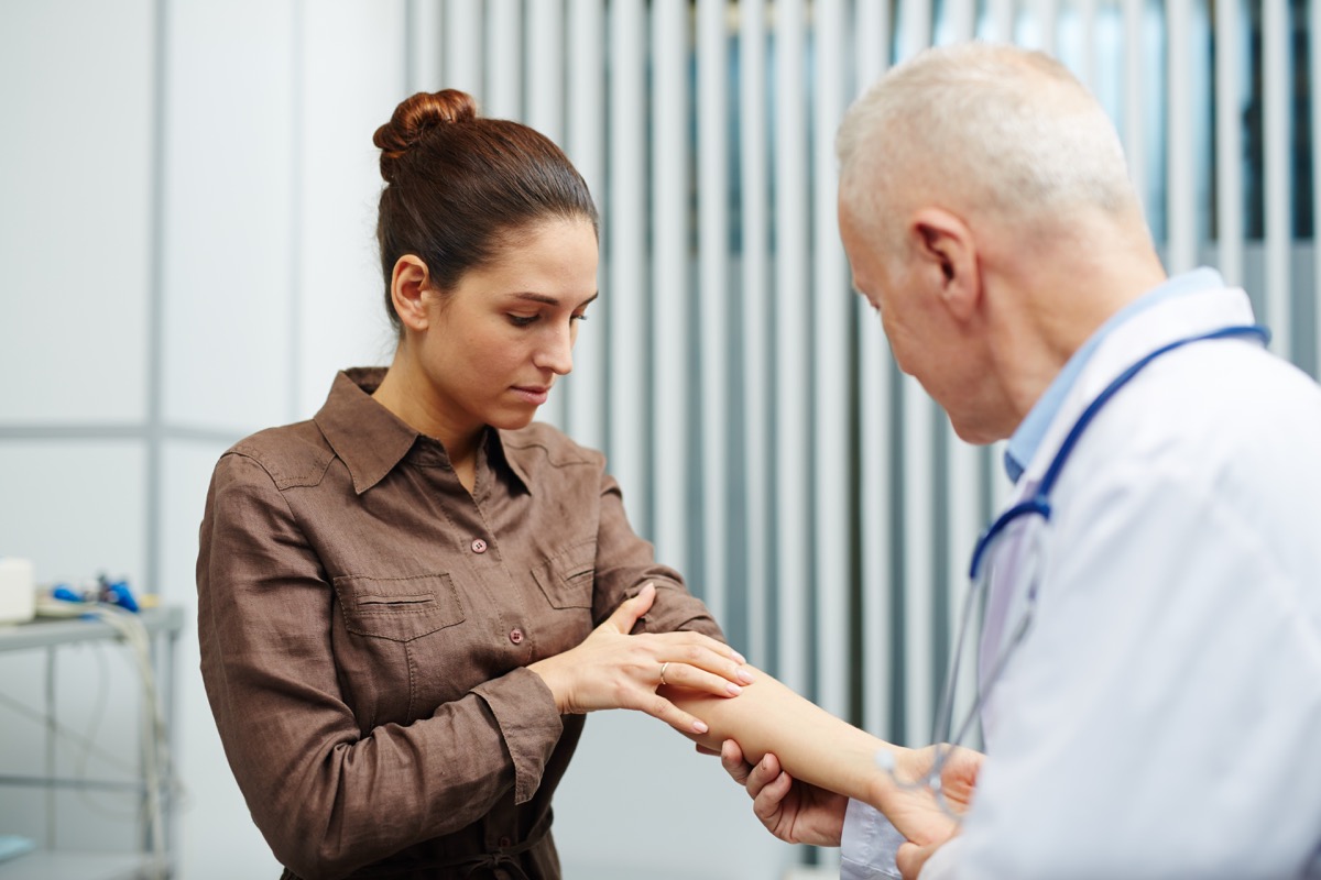 Woman showing doctor her arm