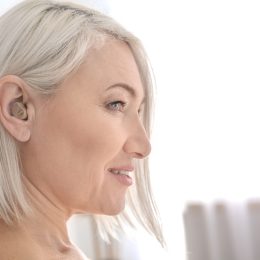 Silver haired mature woman with hearing aid
