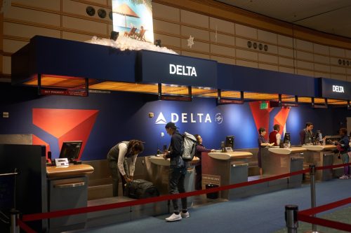 A passenger checks his baggage at the Delta Air Lines check-in desk in Portland International Airport.