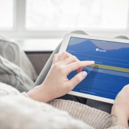 Kiev, Ukrain - February 10, 2018: Woman using Expedia app on a brand new Apple iPad Pro Silver, 7th generation of the iPad, developed by Apple inc. and was announced on March 21, 2016