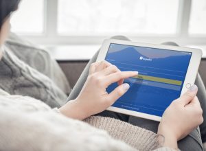 Kiev, Ukrain - February 10, 2018: Woman using Expedia app on a brand new Apple iPad Pro Silver, 7th generation of the iPad, developed by Apple inc. and was announced on March 21, 2016