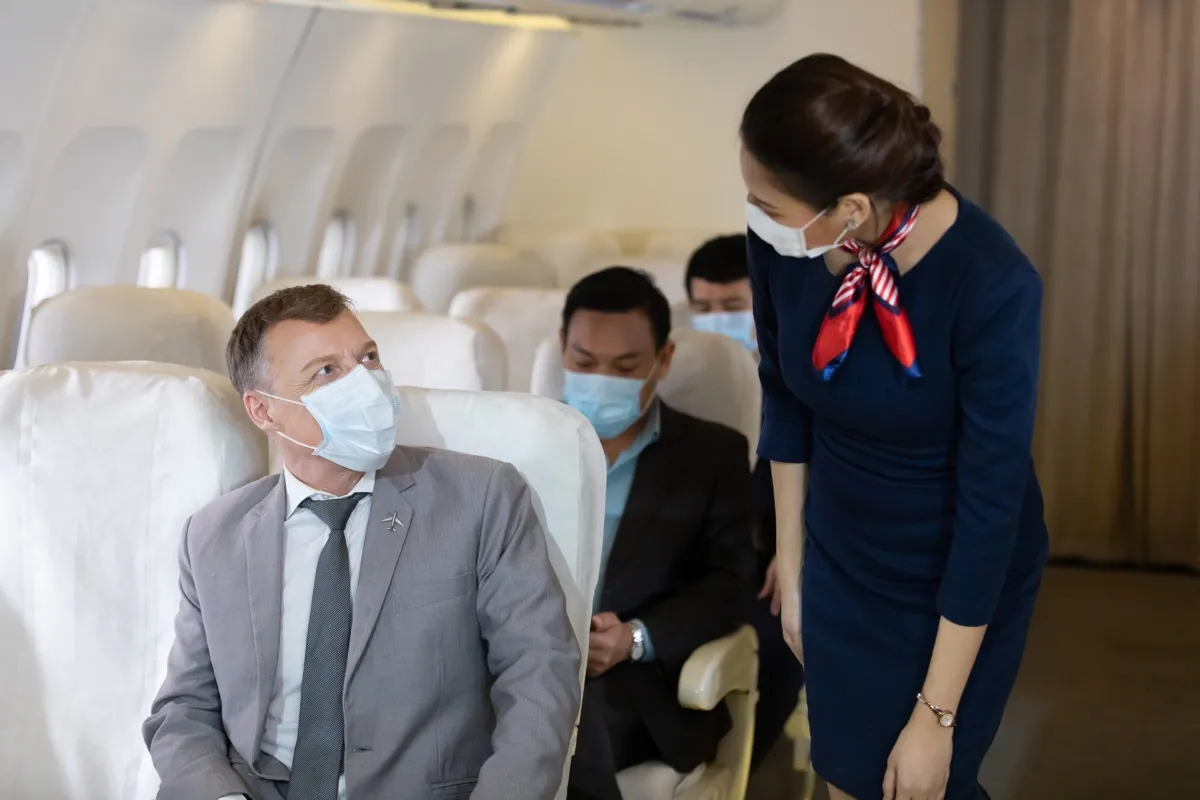 Stewardess talks to passenger