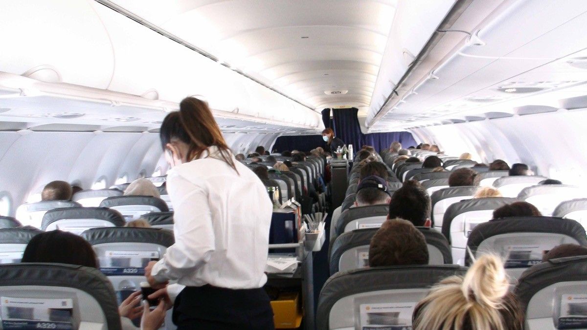 Inside Lufthansa Airlines, Air Stewardess Serving Food And Drinks To People