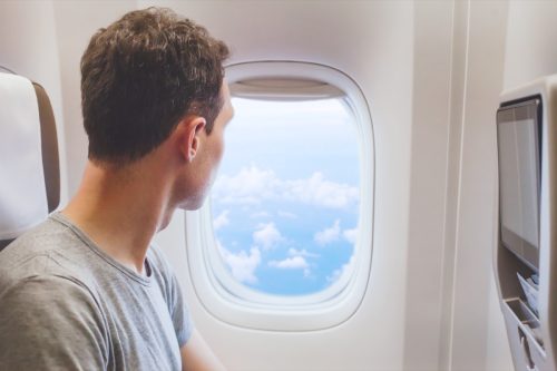 Man looking out of an airplane window