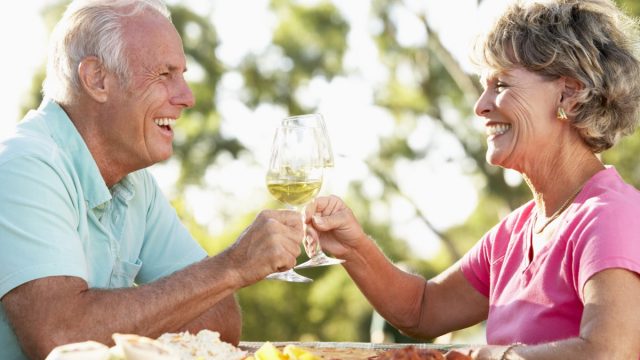 older couple drinking wine outdoors