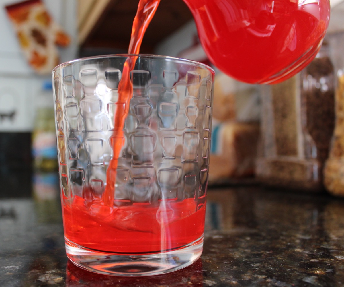 red kool aid pouring into glass