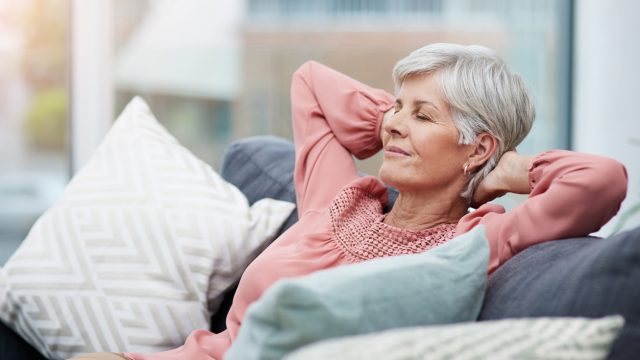 A senior woman relaxing and resting on the couch