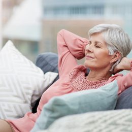A senior woman relaxing and resting on the couch