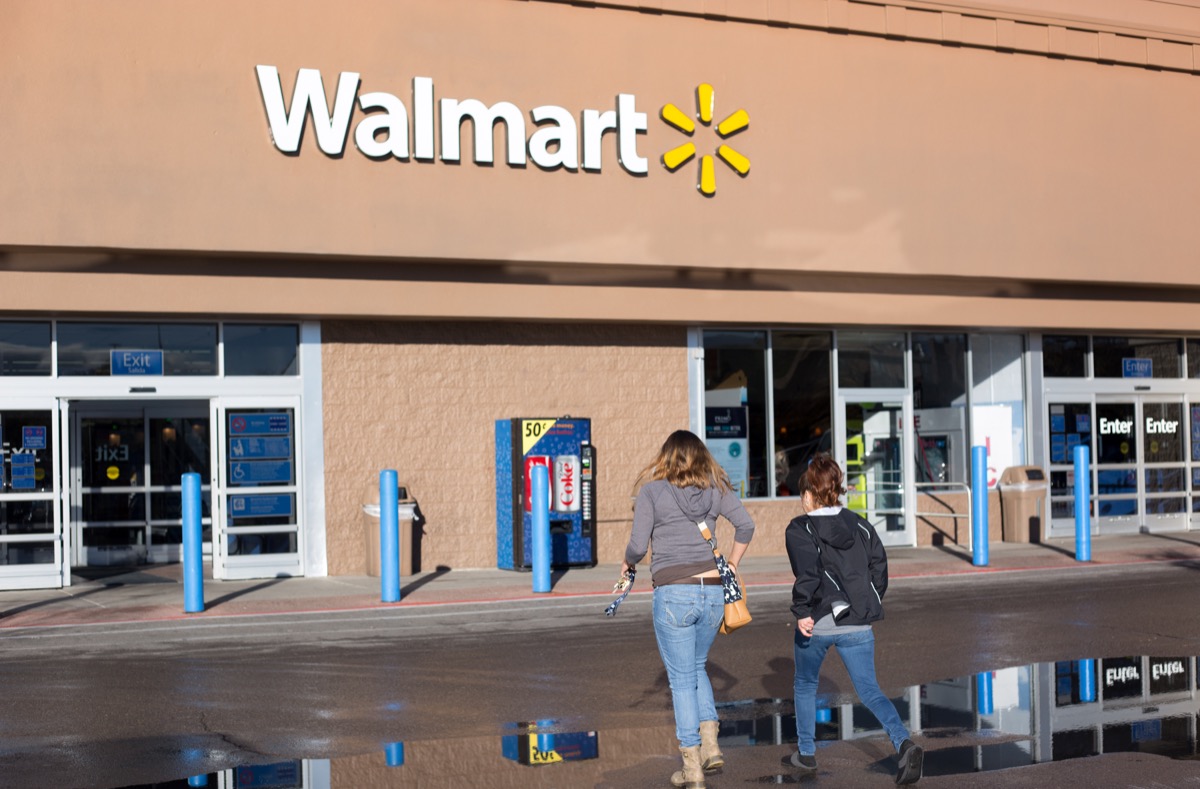 Santa Fe, NM: Two young women approach Walmart. The store is constructed in the Pueblo architectural style.