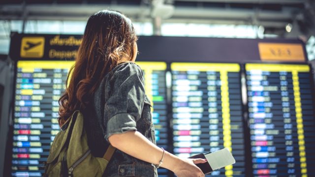 Woman looking at departures at airport
