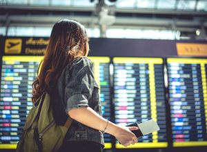 Woman looking at departures at airport