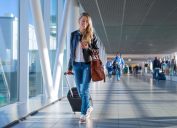 young blonde woman walking through airport