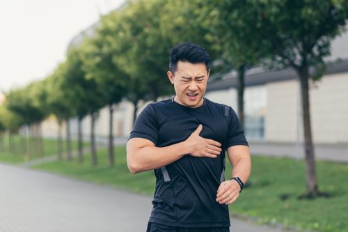 Fit young asian man having chest pain or stroke