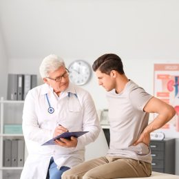 Young man visiting urologist in clinic kidney screening