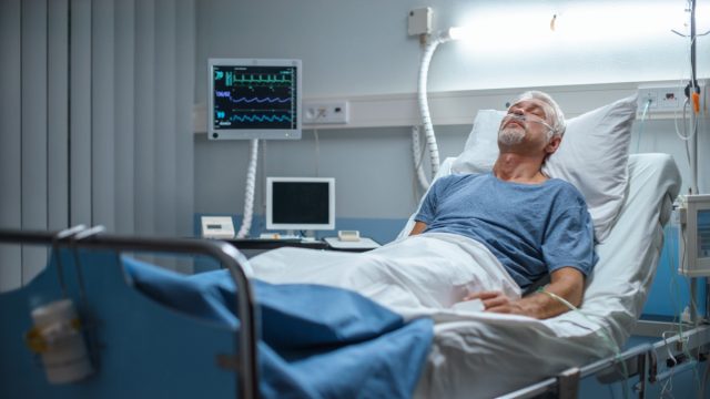 Man in hospital bed sleeping