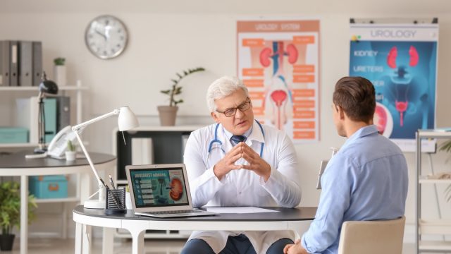 Young man visiting urologist in clinic, kidney doctor