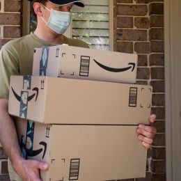 Amazon prime boxes and delivered to a front door of residential building during the COVID-19 pandemic.