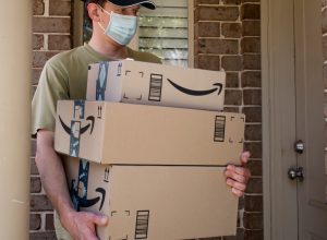Amazon prime boxes and delivered to a front door of residential building during the COVID-19 pandemic.