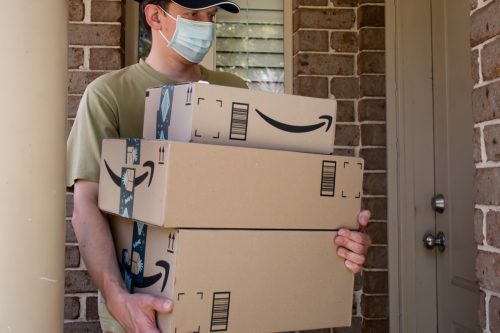 Amazon prime boxes and delivered to a front door of residential building during the COVID-19 pandemic.