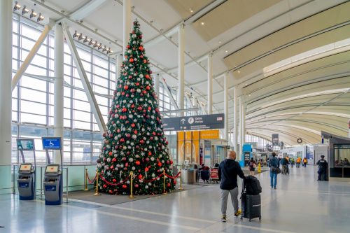 A passenger passed by a Christmas tree at Pearson Airport in Toronto. Pearson Airport is the largest and busiest airport in Canada.