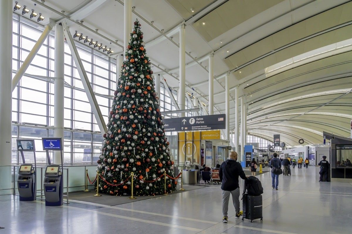 A passenger passed by a Christmas tree at Pearson Airport in Toronto. Pearson Airport is the largest and busiest airport in Canada.