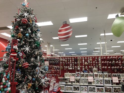 Target store's Christmas holiday department shows a tree decorated with ornaments for sale and cardboard displays hang from the celing